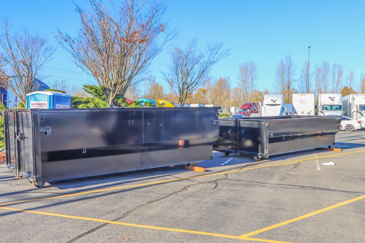 Professional dumpster rental service with roll-off container on residential driveway in Tehachapi